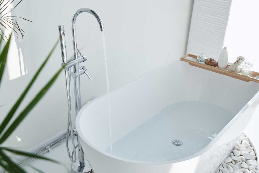 A bathroom with a tub and a plant. Repipe Plumbing ensures efficient plumbing services for your bathroom needs.