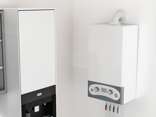 A white wall-mounted gas boiler next to a white wall cabinet.